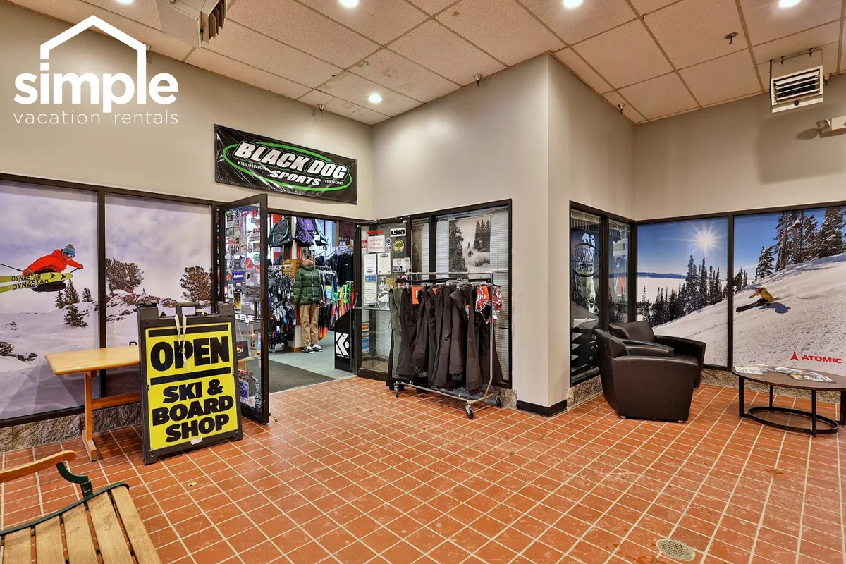 This interior image highlights the entrance to the on-site ski and board shop, complete with gear displays and a comfortable seating area for guests. The inviting atmosphere encourages both shopping and socializing.