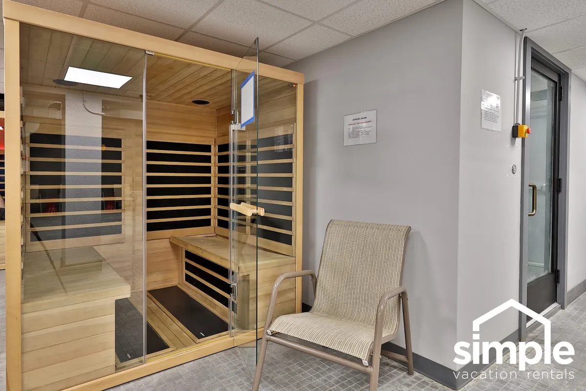A tranquil sauna room featuring wooden benches and a peaceful atmosphere, perfect for unwinding and soothing tired muscles after a day outdoors.